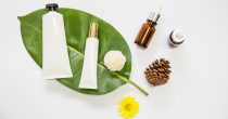 spa-cosmetics-product-leaf-with-essential-oil-pinecone-flowers-white-background