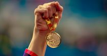 hand-woman-raising-olympic-gold-medal-victory